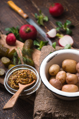 Naklejka premium Ingredients for rustic vegetable salad on the wooden table vertical