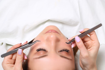 Eyelash Extension Procedure. Woman Eye with Long Eyelashes. Lashes, close up, selectve focus.