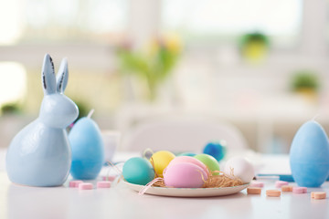 Easter decorated table with painted eggs and rabbit