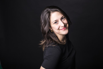 young caucasian woman portrait on black background