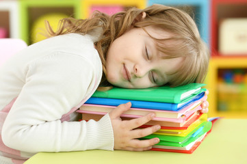 Girl sleeping on books