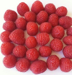 Red raspberries on white background, closeup