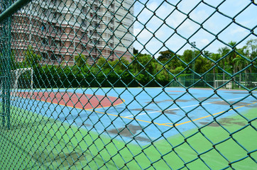 Steel mesh fence with soccer field background