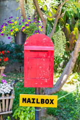 old red wooden mailbox in the garden