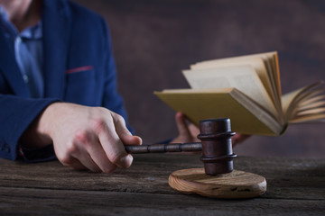 Law and justice concept. Lawer hand, Brown wooden background beautiful reflections. Place for typography and logo