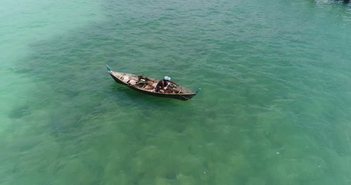 Aerial view of sea and fisherman on the boat