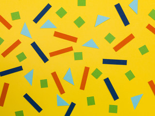 Random Pattern of Geometric Shapes on a Yellow Background