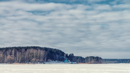 Little House on the shore of the winter lake.