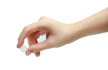Hand holding a pill between thumb and forefinger isolated on white background. manicured hand