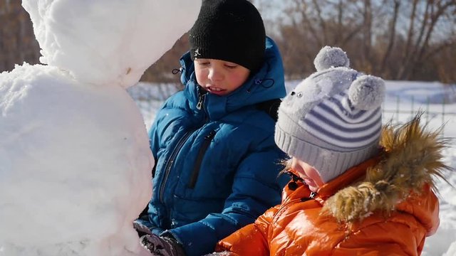children making a snowman in the Playground