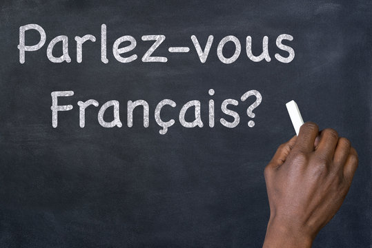 Question "Parlez-vous Francais?" written on a blackboard
