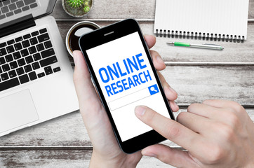 Man is using online research application.