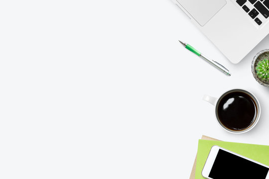 White office desk table with laptop and supplies. Top view with copy space, flat lay.