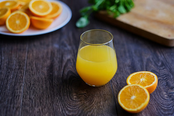 Orange juice in a glass on a wooden table.