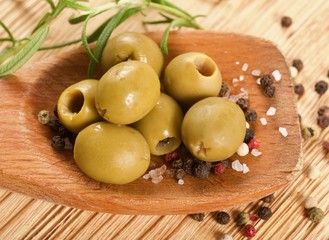 green olives on a wooden background