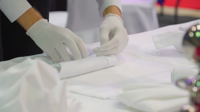 12903_The_folding_of_a_white_tablecloth_for_display.mov