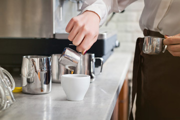 Fototapeta na wymiar barista is preparing coffee on coffee machine