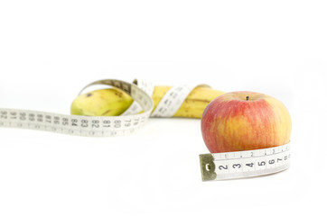Apple And Banana With Measuring Tape Closeup On White Background