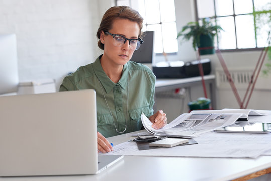 Female architect working with drawings