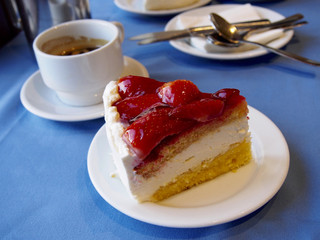 Strawberry cake with coffee on blue background