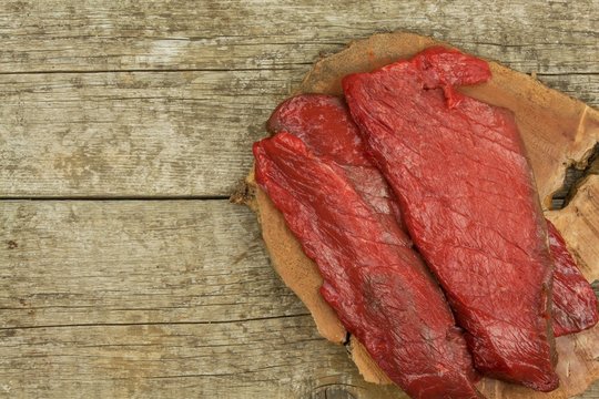 Preparing for grilling. Raw beef on a wooden board. Homework steak.
