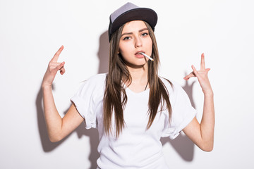 sexy smoking beautiful woman in cap with cigar closeup studio shot
