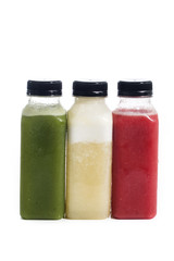 Fresh vegetable detox juice on plastic bottle over a white background
