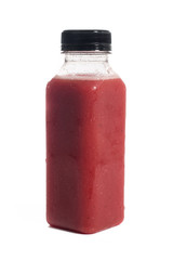 Fresh vegetable detox juice on plastic bottle over a white background