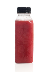 Fresh vegetable detox juice on plastic bottle over a white background