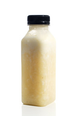Fresh vegetable detox juice on plastic bottle over a white background