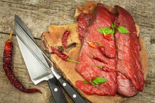 Preparing for grilling. Raw beef on a wooden board. Homework steak.