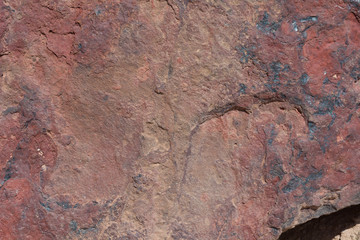 Textured surface of colorful rock