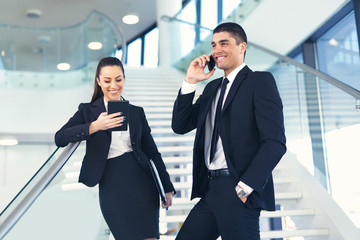 Portrait of two business people on the stairs