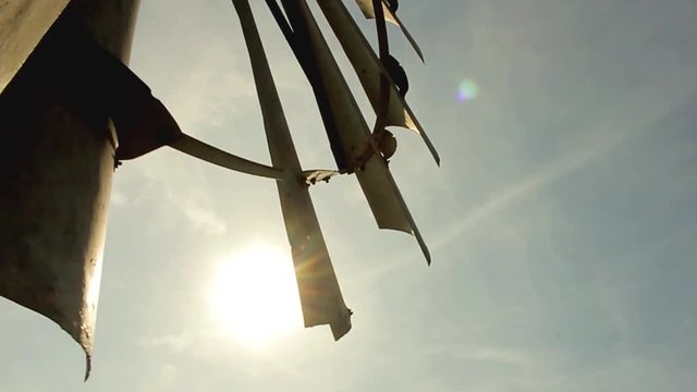 Old Windmill Blades Rotating on Farm at Sunset
