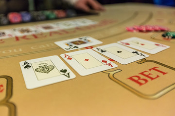 gambling chips and cards on a game table roulette