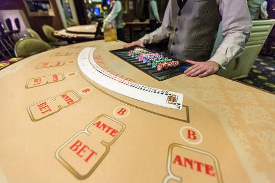 gambling chips and cards on a game table roulette