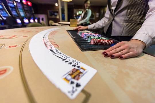 gambling chips and cards on a game table roulette