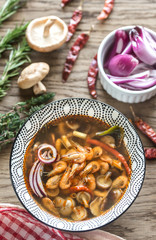 Bowl of thai tom yum soup on the wooden background