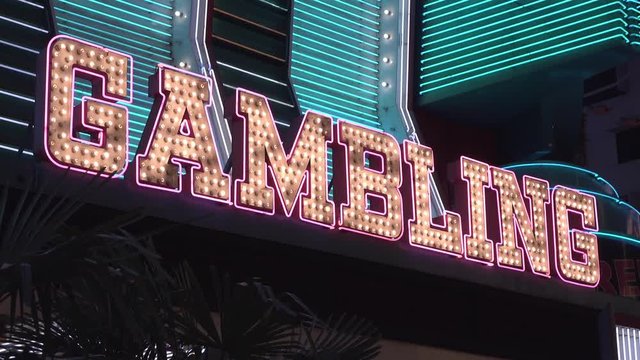 Gambling sign on casino exterior flashing to attract customers.
