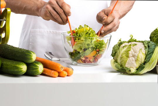 man hand cook make mix vegetables salad on kitchen