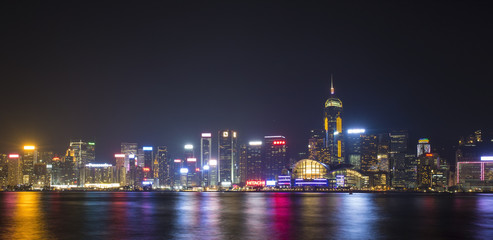 Stunning view of Hong Kong skyline and Victoria harbour seen from Harbour City from where is possible to attend the Symphony of Light, smooth water flowing in the foreground, Hong Kong.