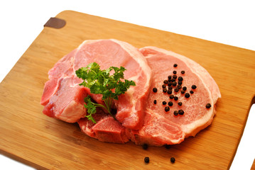 Fototapeta premium Fresh Lean Pork Chops on a Cutting Board 
