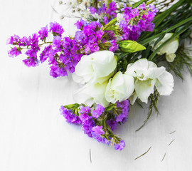 Flowers bouquet on wooden background