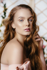 Portrait of a beautiful fashion, sweet and sensual. make up and hair. Perfect Skin. Flowers background. Art modern style. Blue eyes. Natural manicure.