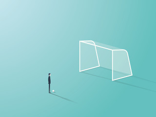 Businessman standing in front of soccer or football goal empty net with ball waiting to shoot or kick it.