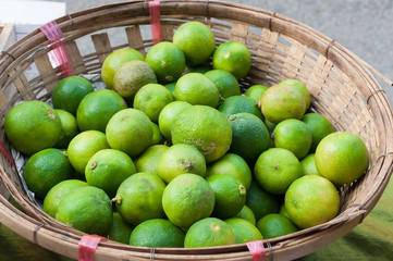 fresh green lime in basket at market thailand asia