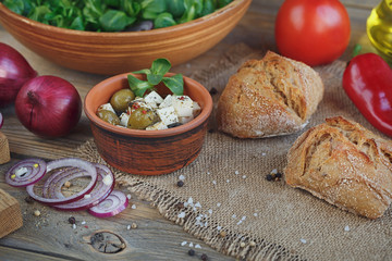 Ingredients for vegetables salad on a wooden background.