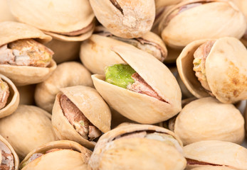 Pile of salted pistachio nuts close up