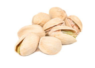 Several pistachio nuts on a white background