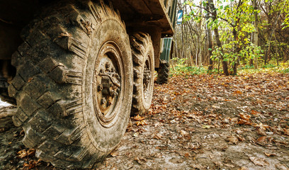 Fototapeta na wymiar View of wheels of heavy truck in autumn forest area